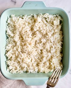 rice in a blue dish with a fork