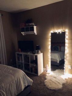 a bedroom with lights on the wall and a bed