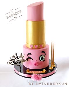 a pink and gold cake with eyes on it