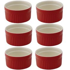 six red and white dishes stacked on top of each other in a row with the lids down