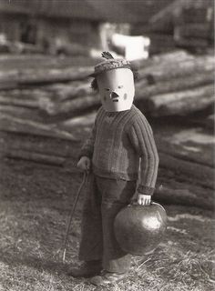 an old black and white photo of a baby holding a ball