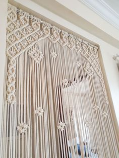 an intricately designed curtain is hanging on the wall