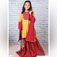 Gold Printed Shirt With Sheesha Embellishment Paired With Printed Gharara. 3 Piece Set. Comes With Kameez, Gharara And Potluck Cloth Bag. Brand New With Tags. Indian Pakistani Kids Designer Out. Size 4-5t. Mirror Work Embellishments. Yellow Palazzo Set With Dabka For Navratri, Yellow Dabka Palazzo Set For Navratri, Navratri Yellow Dabka Palazzo Set, Festive Yellow Palazzo Set With Long Sleeves, Yellow Long Sleeve Palazzo Set For Festive Occasions, Yellow Dabka Palazzo Set For Festivals, Yellow Palazzo Set With Dabka For Festivals, Festive Yellow Palazzo Set With Dabka Detailing, Yellow Palazzo Set With Dabka For Diwali