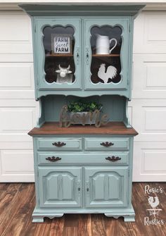 a blue hutch with two glass doors