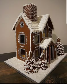 a gingerbread house is decorated with icing and snow