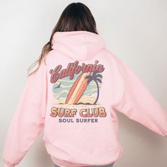 California Surf Club Hoodie, the perfect beachy sweatshirt for surf enthusiasts and coconut girls alike. This summer hoodie captures the essence of California's surf culture with its laid-back style and vibrant design. Made with high-quality materials, this surf hoodie is not only stylish but also comfortable, making it ideal for those breezy beach days or cozy nights by the bonfire. Channel your inner surfer with the California Surf Club Hoodie and embrace the carefree spirit of the California coast. 🖤 For oversized order 1-3 sizes up, refer to listing photos for sizes. RUNS ON THE SMALLER SIDE 🖤 Gildan 18500 🖤 Some Shrinkage may occur with washing 🖤 This unisex heavy blend hooded sweatshirt is relaxation itself.  🖤 Made with a thick blend of cotton and polyester, it feels plush, sof Pink Cotton Sweatshirt For The Beach, Casual Pink Beach Sweatshirt, Casual Surfing Hoodie Sweatshirt, Casual Surfing Hoodie With Graphic Print, Casual Letter Print Hoodie For Beachwear, Sporty Long Sleeve Beach Hoodie, Trendy Hooded Hoodie For Beach Season, Trendy Long Sleeve Beach Hoodie, Beach Vsco Long Sleeve Hoodie