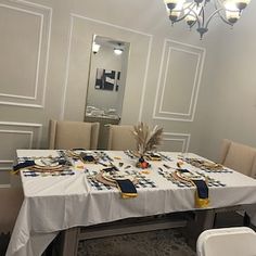 a dining room table is set up with place settings for two people to sit at