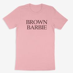 Be the definition of cool with this Brown Barbie Tee! It's unisex fit is perfect for all fans of Barbie, making you the envy of all your friends. Plus, with 3-7 business days for processing, you'll be ready to rock in no time! Ring-spun Cotton Tops With Text Print, Band Merch Style, Unisex Letter Print T-shirt For Fans, Ring-spun Cotton Tops With Text Print For Band Merch, Unisex Letter Print T-shirt Fan Merchandise, Band Merch Tops In Ring-spun Cotton With Text Print, Band Merch Tops With Text Print, Unisex T-shirt With Text Print For Fan Merchandise, Unisex Letter Print T-shirt In Pop Culture Style, Barbie Teacher Shirt