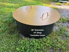 a large metal object sitting on top of a lush green field