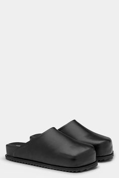 These clogs are inspired by the shoes that truckers wear on the road. easy slip on shoe. square shaped outsole. soft hand feel vegan leather uppers. recycled fibers and plant based sources for over 50%.    colour: black. upper: vegan leather (29% bamboo 19% cotton 52% pu) outsole: 100% rubber. footbed: 100% pu. made in portugal. Slip On Shoe, Tiny Cottons, Birkenstock Boston Clog, American Rag, Womens Sandals Flat, Soft Hands, Mens Fashion Trends, On The Road, Slip On Shoes