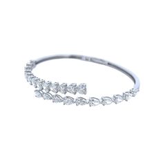 This 18K white gold bangle features a beautiful overlap of heart and pear-shaped diamonds that add up to 6.40 TCW. Its timeless design is ideal for any special occasion. DIAMOND 4.06 HS TCW 13 PCS. F-G VS2 &2.34 PS TCW 10 PCS. F-G VVS2-VS1 BS-1538 Silver Pear-shaped Diamond Bracelet For Anniversary, Fine Jewelry Pear-shaped Diamond Bracelet For Wedding, Wedding Fine Jewelry Diamond Pear-shaped Bracelet, Pear-shaped Diamond Bracelet For Weddings, White Gold Pear-shaped Wedding Bracelets, Elegant White Gold Pear-shaped Bracelets, Pear-shaped White Gold Bracelets For Wedding, Pear-shaped Brilliant Cut Diamond Bracelet For Formal Occasions, Pear-shaped White Gold Wedding Bracelets