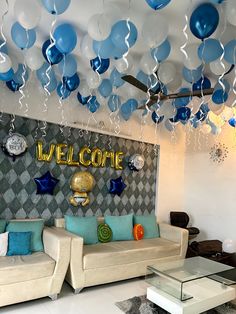 a living room filled with couches covered in blue and white balloons