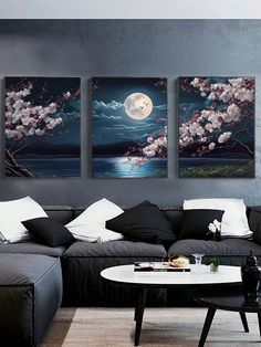 a living room with three paintings on the wall