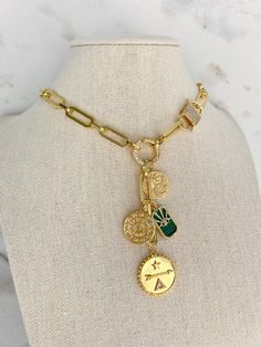 A 1 of 1 exclusive from our Charm Necklace Collection! This beautiful piece is 14k Gold Filled and detailed with fun charms. The circle connector in the middle opens so you can add or remove more charms of your own!  + 14k Gold Filled Chain  + 18" in length - this includes the chain around the neck + 2.5" drop  + Lobst Luxury Gold-plated Charm Necklaces, Luxury Gold Plated Charm Necklace, Luxury Gold Necklaces With Removable Charms, Gold Medallion Charm Necklace With Detachable Pendant, Yellow Gold Medallion Charm Necklace, Gold Charm Necklace With Medallion, Round Gold Plated Charm Necklaces, Winter Jewelry, Green Eye