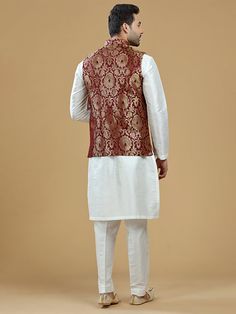 A gold zari brocade vest to pair with any kurta with statement button closures at the front. Occasion: Style this vest with pajama pants and a kurta for a welcome dinner or sangeet night, or style it with a any dress shirt and trousers for a sleek Indian wedding reception look! WASH CARE INSTRUCTIONS - Please Dry clean only. Slight color variation is possible due to digital photography. **Kurta & Pajama not included Sleeveless Nehru Jacket With Zari Work, Sleeveless Nehru Jacket With Zari Work For Transitional Season, Sleeveless Bandhgala For Eid, Traditional Sleeveless Bandhgala With Zari Work, Traditional Sleeveless Kurta With Zari Work, Designer Sleeveless Kurta For Transitional Season, Bollywood Style Sleeveless Dabka Set, Sleeveless Bandhgala For Festivals, Sleeveless Nehru Jacket For Diwali