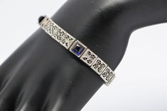 "14K white gold filigree sapphire bracelet in Art Deco style, Circa 1925, Platinum on 14K gold, 3 square sapphire stones, high dome cabochons, 7\" length, 1/4\" wide, weight 14.6 grams. Stock # BB90B19" Elegant Sapphire Jewelry With Intricate Design, Art Deco Silver Sapphire Jewelry, Art Deco Sapphire Silver Jewelry, Art Deco Gemstone Bracelet For Formal Occasions, Antique Blue Platinum Jewelry, Silver Sapphire Filigree Jewelry, Silver Sapphire Jewelry With Filigree, Rectangular Platinum Jewelry With 17 Jewels, Art Deco Jewelry With Cabochon For Formal Events