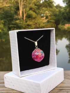 This is a handcrafted resin orb necklace. I created this rainbow epoxy resin necklace with translucent rainbow pieces and eco epoxy resin. I have added a small amount of pink ink dye colorants. This is a beautiful necklace that would be great to add to your collection or as a special gift! Orb Sizing 1.25x .75 inches Chain Choices 18 inch sterling silver plated 20 inch sterling silver plated 20 inch stainless steel  Free domestic shipping (USPS First Class) on orders of $35 or more! All necklace Adoption Gifts, Resin Necklace, Epoxy Resin, Resin Jewelry, Drawstring Bag, Jewelry Care, Beautiful Necklaces, Special Gifts, Necklace Lengths