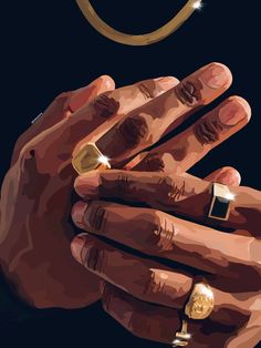 a man's hand with two gold rings on it and a diamond ring in the middle