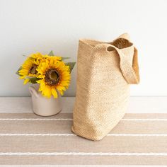 Take on the summer with our handmade raffia straw bag! With a large opening and inner pocket, this beach bag is perfect for all your sunny essentials. Simple, durable, and oh-so-cool, this large shoulder bag is the ultimate summer companion. Get ready to turn heads with this unique, stylish statement piece! Natural Soft Raffia Straw Handmade Unlined Inside pocket Size: 13"H x 15"W x 5"D Strap drop length: 12" Designer Style ID: 8621 Summer Burlap Tote Shoulder Bag, Lightweight Jute Bag In Natural Color, Beige Burlap Shoulder Bag For Summer, Lightweight Natural Color Beach Bag For Everyday Use, Lightweight Rectangular Jute Beach Bag, Lightweight Natural Jute Bag, Summer Burlap Tote Bag, Eco-friendly Lightweight Jute Beach Bag, Natural Lightweight Beach Bag For Daily Use