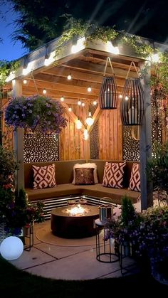 an outdoor living area with furniture and lighting