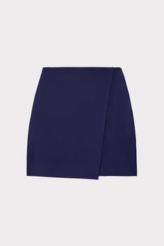 The Evalyn looks like a mini skirt from the front, thanks to its envelope-shaped overlay at front, but it’s actually a comfortable skort that pairs well with a variety of different MILLY tops. Cut from a luxe crepe fabric, it sits at the hips and has a hidden back zipper closure. Chic Lined Mini Wrap Skirt, Elegant Workwear Shorts With Lined Skirt, Elegant Lined Skort With Short Inseam, Elegant Skort With Lined Skirt And Short Inseam, Elegant Relaxed Skort With Short Inseam, Elegant Skort With Short Inseam, Elegant Short Inseam Lined Skirt Skort, Chic Short Lined Wrap Skirt, Elegant Short Wrap Skirt For Workwear