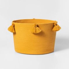 a large yellow basket with tassels