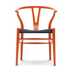 an orange wooden chair with a white seat and back rest in front of a white background