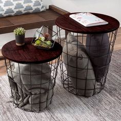 two tables sitting on top of a rug in front of a bench with a plant