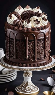 a chocolate cake sitting on top of a table next to plates and utensils