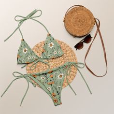 A sage green triangle bikini set with meadow flowers and sage green lining channels bohemian vibes. This bikini comes in sizes up to 6XL. It's made from recycled material. It can be tied in multiple ways. Flattering fit and pattern make a perfect addition to your swimwear collection. Please check the sizing chart between the listing photos. Item description: - fabric composition in Latvia: 88% recycled polyester, 12% elastane, - fabric composition in Mexico: 81% recycled polyester, 19% Lycra spa Green Swimwear For Poolside Spring, Fitted Green Swimwear For Vacation, Green Triangle Top Swimwear For Spring, Green Tropical Swimwear For Spring, Green Swimwear For Sunbathing On Vacation, Green Floral Print Swimwear For Summer, Bohemian Green Swimwear For Spring, Green Bohemian Swimwear For Spring, Green Tropical Swimwear For Festival