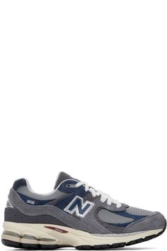 Casual New Balance Sneakers With Logo Patch, Blue Lace-up Sneakers With Logo Patch, New Balance Sneakers With Logo Patch For Sports, New Balance High-top Sneakers With Embroidered Logo, New Balance Embroidered Logo Sneakers For Streetwear, New Balance Sneakers With Embroidered Logo For Streetwear, Gray Casual Sneakers With Logo, Lace-up Sports Sneakers With Appliqué Logo, Lace-up Sneakers With Appliqué Logo For Sports