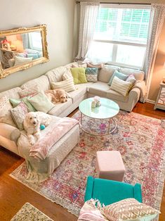 a living room filled with furniture and a large rug on top of a hard wood floor