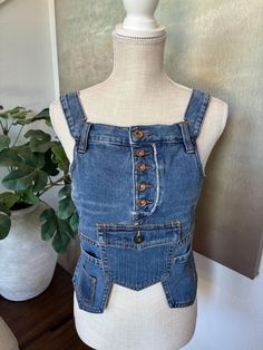 Size:  Small 34-35B  This reworked denim corset top has 3 functional pockets to hold all you need so you won't need to carry any purses.  It has that old retro look but also edgy and futuristic.  It covers all the right places and gives it a interesting fashion statement.  It's a must have! 😜 Fitted High Waist Denim Vest, Fitted Denim Blue Top For Festival, High Waist Fitted Jeans For Alternative Fashion, Trendy Fitted High Waist Denim Vest, Summer Utility Fitted Jeans, Trendy Fitted Denim Vest, Fitted Casual Denim Top For Festival, Fitted Utility Jeans For Summer, Fitted Denim Top For Festival