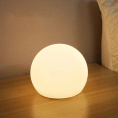 a white light sitting on top of a wooden table