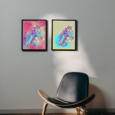 two framed pictures hang on the wall next to a black chair in front of a white wall