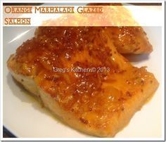 orange marmalade glazed salmon fillets on a white plate with text overlay that reads orange marmalade glazed salmon fillets