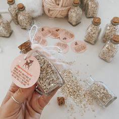 a hand holding a jar filled with granola