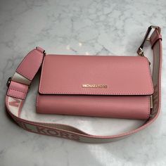 This Michael Kors Crossbody Wallet Is A Must-Have. The Exterior Is Crafted With Leather And Features A Stunning Pink Color, While The Interior Is Lined With A Matching Pink Hue. The Wallet Has A Stylish Crossbody Design That Makes It Easy To Carry Around, Giving You The Freedom To Move Around Without Worrying About Your Belongings. It's Suitable For Any Occasion, From Casual Outings To Formal Events. Whether You're Running Errands Or Attending A Party, This Michael Kors Crossbody Wallet Is Sure Michael Kors Leather Bags With Card Slots, Michael Kors Bag With Card Slots For Daily Use, Michael Kors Satchel, Convertible Crossbody Bag, Brown Crossbody Bag, Michael Kors Crossbody Bag, Brown Shoulder Bag, Michael Kors Crossbody, Fancy Bags