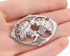 "925 Sterling Silver - Vintage Sparkling Double Flower Basket Brooch Pin - BP1752  925 Sterling Silver - Vintage Sparkling Double Flower Basket Brooch Pin - BP1752  Jewelry Type:         Brooch Pin   Metal Type:            925 Silver  Metal Size:             1.75\"  Stone Type:            N/A  Condition:              N/A  Jewelry Weight:     7.1 Grams  PLEASE NOTE: THIS ITEM IS PRE-OWNED. ALTHOUGH MOST ITEMS ARE IN VERY GOOD CONDITION, SOME MAY NEED CLEANING AND/OR MINOR REPAIRS. WE MAKE A VERY STRONG EFFORT TO UPLOAD CLEAR PICTURES. PLEASE INSPECT ALL PICTURES AND ASK ALL QUESTIONS YOU MAY HAVE PRIOR TO MAKING A PURCHASE. NOT ALL STONES ARE GENUINE, SOME ARE ENHANCED OR CREATED." Sterling Silver Hallmarked Brooches, Classic Silver Brooches With Intricate Design, Silver Art Deco Brooch For Gift, Silver Art Deco Brooch Gift, Classic Silver Filigree Brooches, Elegant Silver Brooches Stamped 925, Silver Art Deco Filigree Brooches, Silver Filigree Brooch For Anniversary, Flower Basket