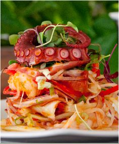 an octopus sandwich is stacked on top of other food