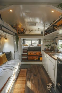 the interior of a camper with bunk beds, kitchen and living room in it