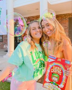 two girls are standing outside with bubbles in front of them and one girl is holding a bag of lucky charms cereal