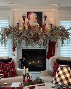 a living room decorated for christmas with stockings and candles on the fireplace mantels