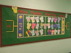 a bulletin board with clothes hanging on it in a classroom hallway at miss poole's starting library