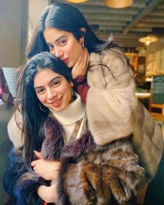 two women in fur coats posing for the camera