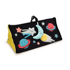 a black and yellow bag with stars, moon and rockets on the front is sitting on a white surface