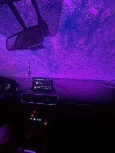 the interior of a car with purple and blue lights on it's ceiling, as seen from inside