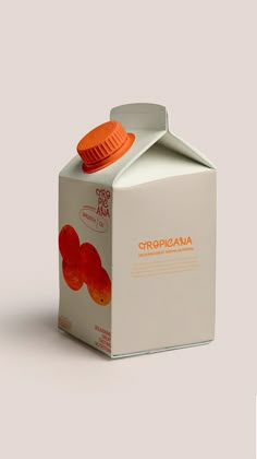 a milk carton with an orange cap on top