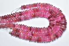 the beads are pink and have been cut into smaller pieces to make it look like they are