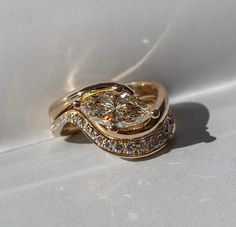 two gold wedding rings with diamonds on them